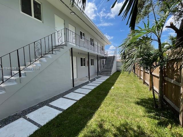 An exterior view of a two-story apartment building with an outdoor staircase and walkway — 1920 NW 151st St # 3, Opa-Locka FL 33054, OPA-LOCKA, FL