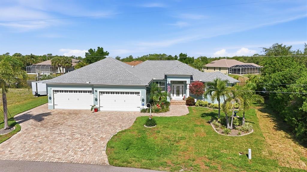 An aerial view of a single-story house with a paver driveway and two-car garage — 15658 APPLEWHITE CIRCLE, PORT CHARLOTTE, FL