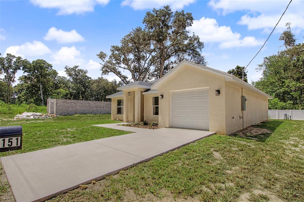A single-story house with a concrete driveway, a one-car garage, and a mailbox — 151 SE 81ST STREET, OCALA, FL
