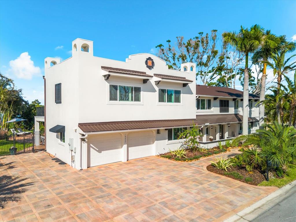 A two-story white stucco house with a two-car garage and a paved driveway — 16895 1ST STREET E, NORTH REDINGTON BEACH, FL