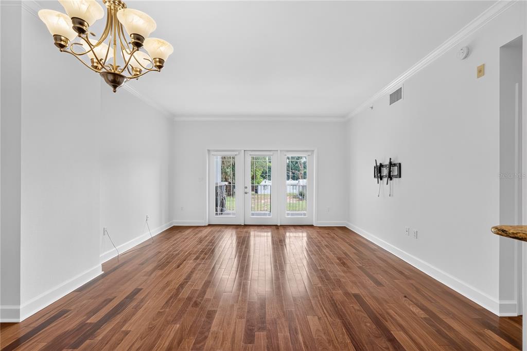 A dining room with hardwood floors, a chandelier, and glass doors leading to the outdoors — 630 VASSAR STREET UNIT 2210, ORLANDO, FL