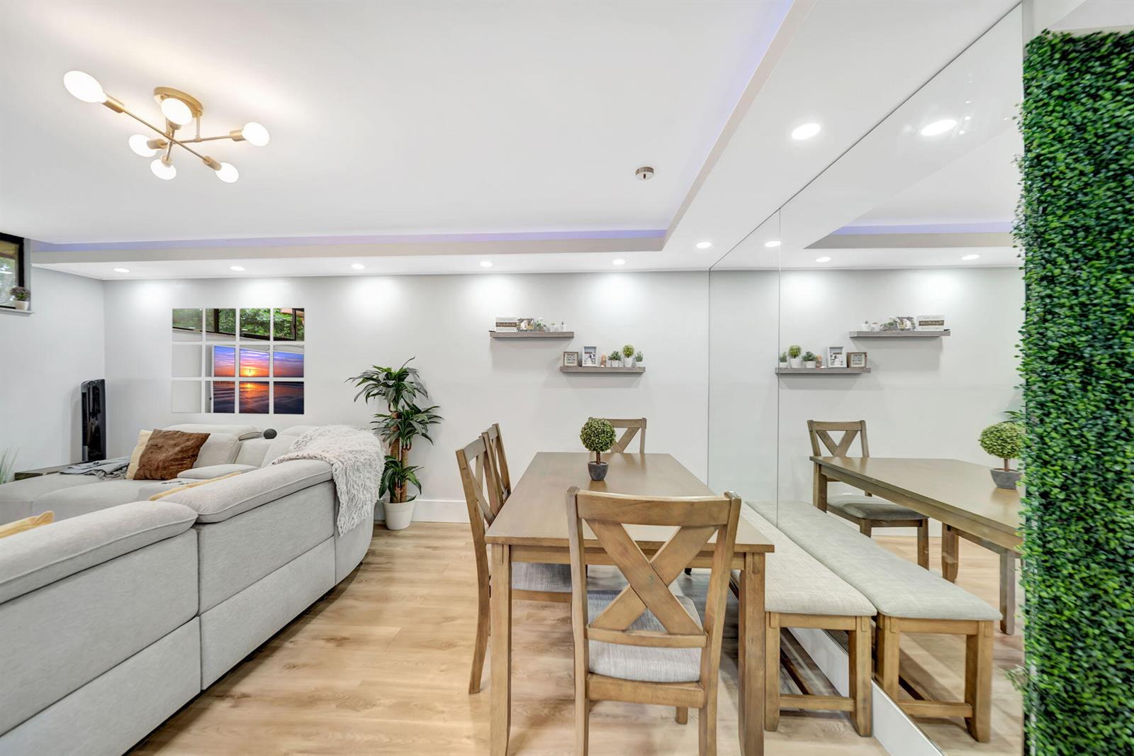 A dining area with a wooden table and chairs sits next to a living room — 8105 Severn Drive # C, Boca Raton FL 33433, BOCA RATON, FL