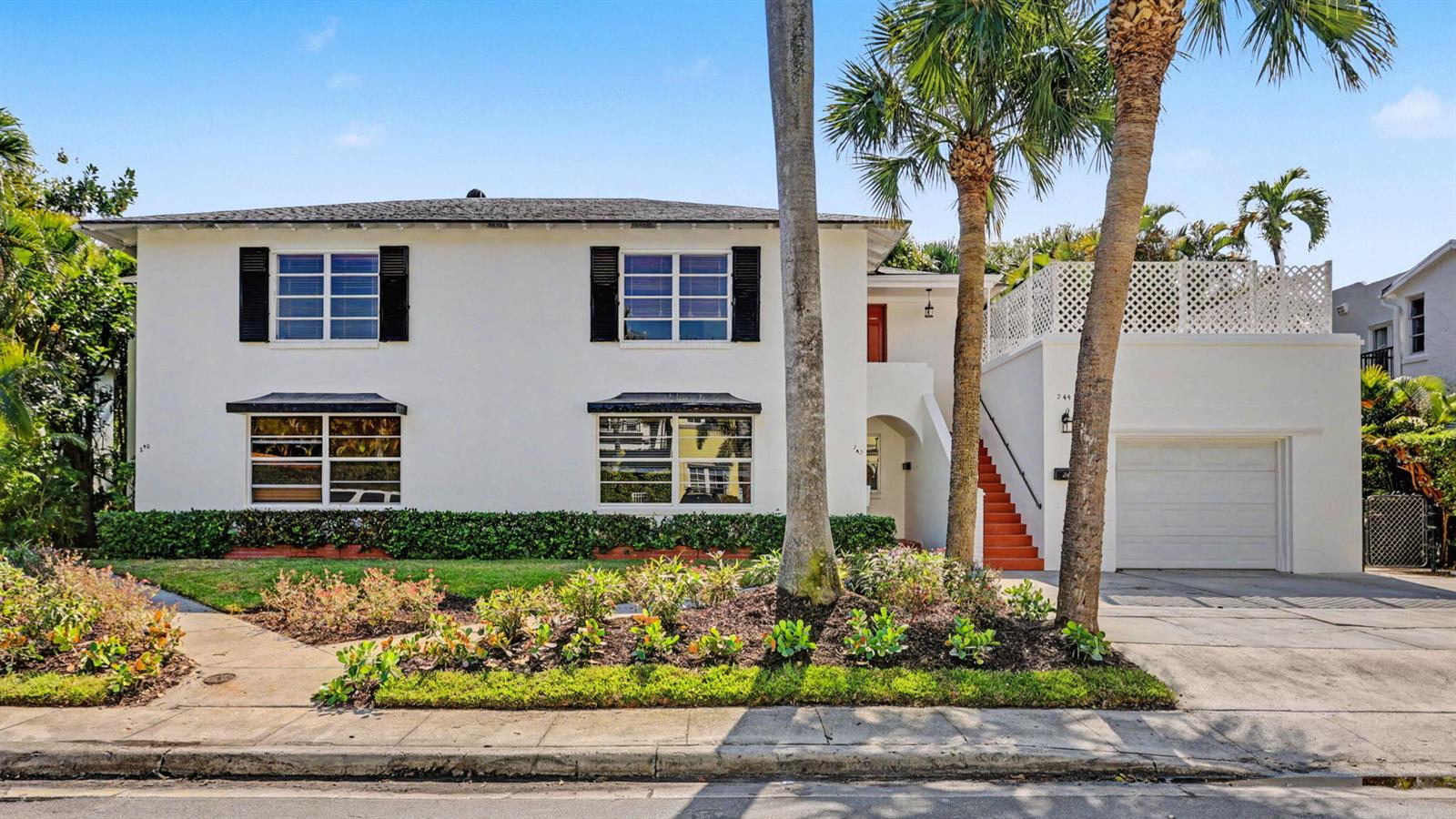 A two-story white house with black shutters, a garage, and a front garden with palm trees — 240 Oleander Avenue, Palm Beach FL 33480, PALM BEACH, FL