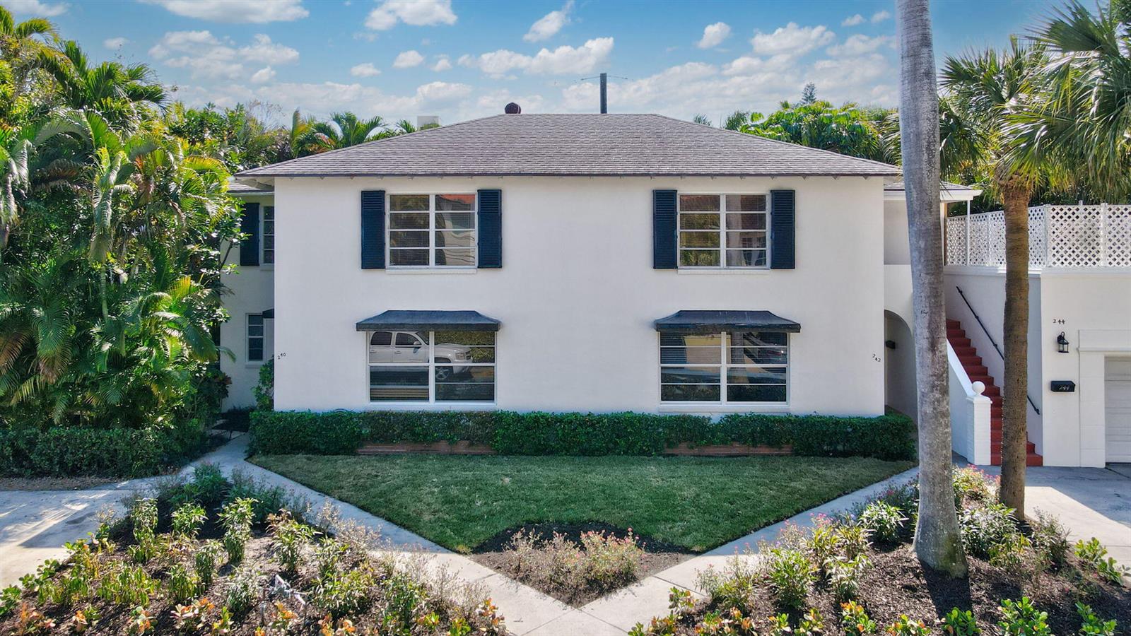 A two-story white building with a hip roof, dark shutters, and a landscaped front yard — 240 Oleander Avenue, Palm Beach FL 33480, PALM BEACH, FL