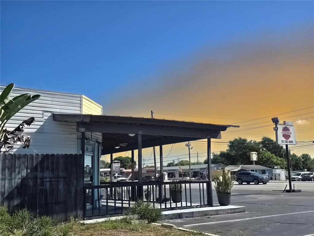 An exterior view of a commercial building with a covered porch and a parking lot — 11002 SEMINOLE BOULEVARD, LARGO, FL