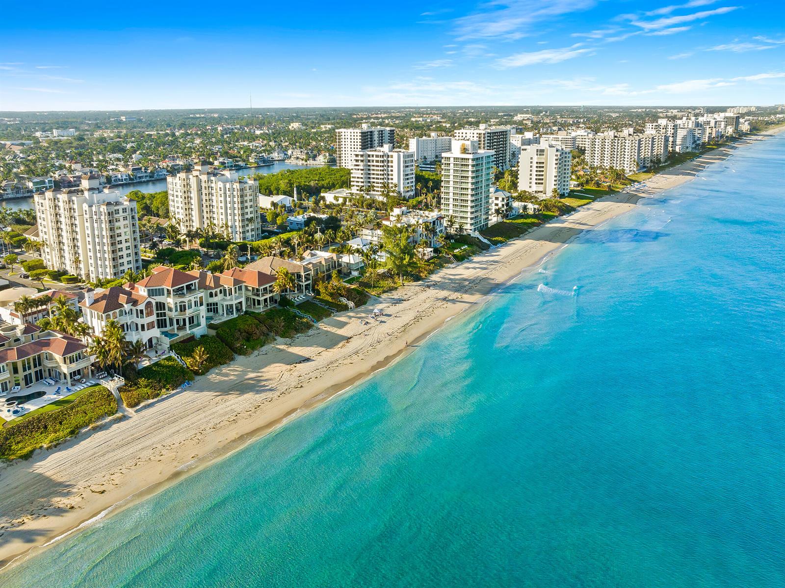 Aerial view of a coastal beach with luxury residential buildings and houses along the shore — 3606 S Ocean Boulevard # 1004, Highland Beach FL 33487, HIGHLAND BEACH, FL