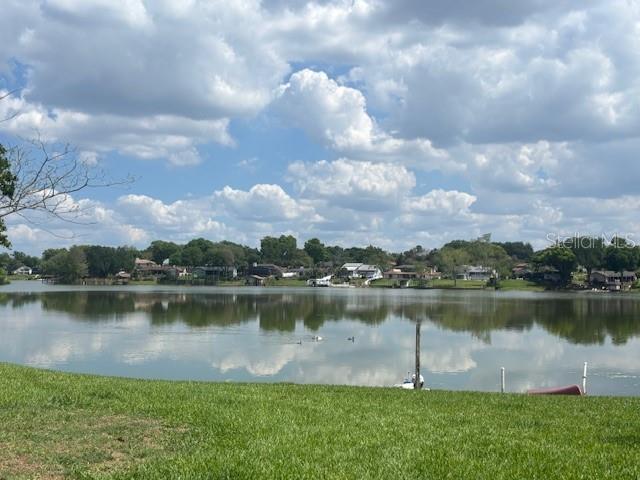 A view of a lake with houses along the distant shoreline under a cloudy sky — 528 ORANGE DRIVE UNIT 26, ALTAMONTE SPRINGS, FL