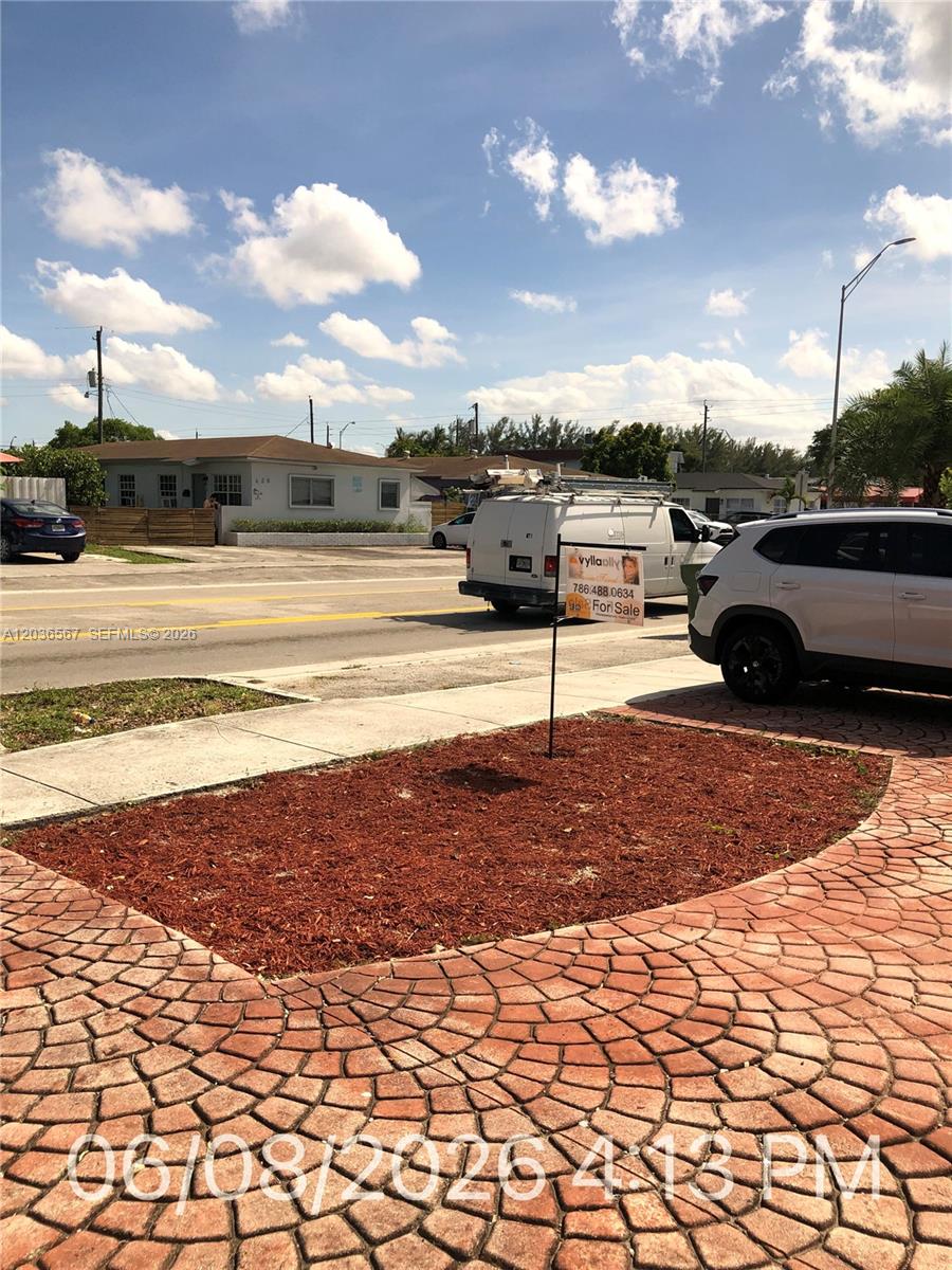 A white van and a white SUV are parked on a street near a house — 447 E 32nd St, Hialeah FL 33013, HIALEAH, FL