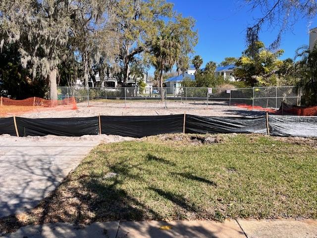 A fenced, cleared residential lot features a black silt fence in the foreground — 2640 S DUNDEE STREET, TAMPA, FL