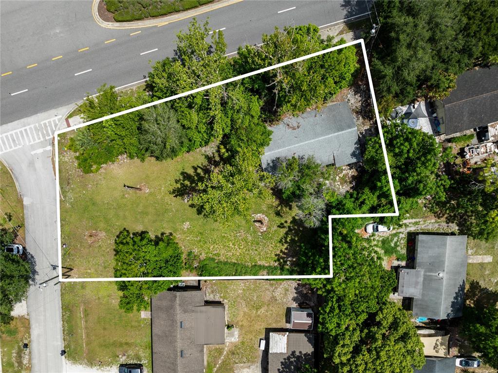 An aerial view shows a residential lot with a house, trees, and surrounding streets — 3711 N RONALD REAGAN BOULEVARD, LONGWOOD, FL