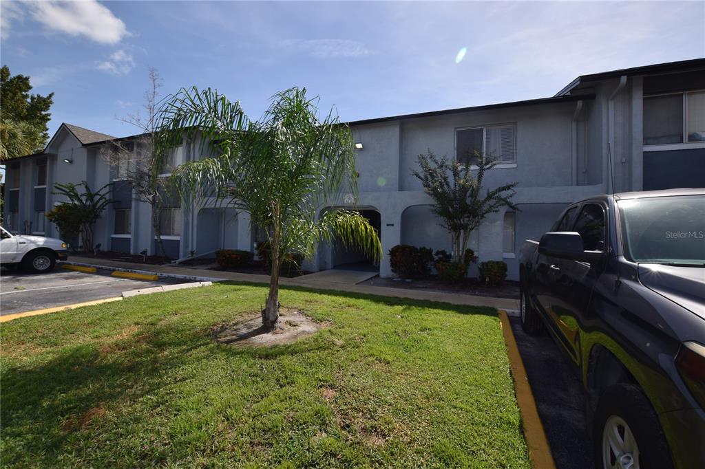 A two-story apartment building with a palm tree in the foreground and parked vehicles — 4703 S TEXAS AVENUE UNIT 4703A, ORLANDO, FL