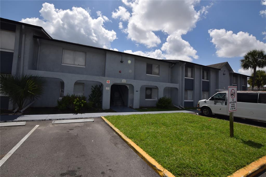 A two-story apartment building exterior with a parking lot and a grassy lawn — 4703 S TEXAS AVENUE UNIT 4703A, ORLANDO, FL