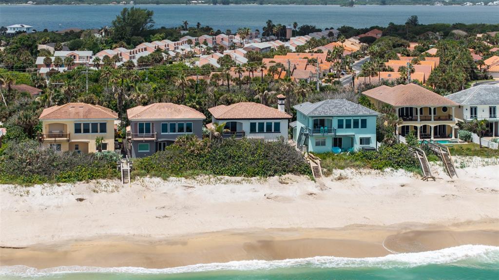 An aerial view of several beachfront houses with private wooden staircases leading to the sand — 5595 S HIGHWAY A1A, MELBOURNE BEACH, FL