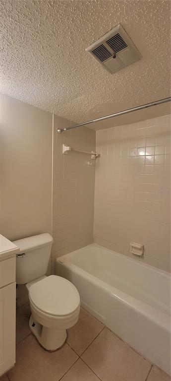 A bathroom features a white toilet, a tiled bathtub with a shower rod, and a vent — 3810 W SAN CARLOS STREET UNIT 314, TAMPA, FL
