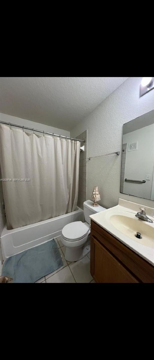 A bathroom features a shower-tub combination, a white toilet, and a wooden vanity with sink — 14890 pleasant bay lane # 3102, Naples FL 34119, NAPLES, FL