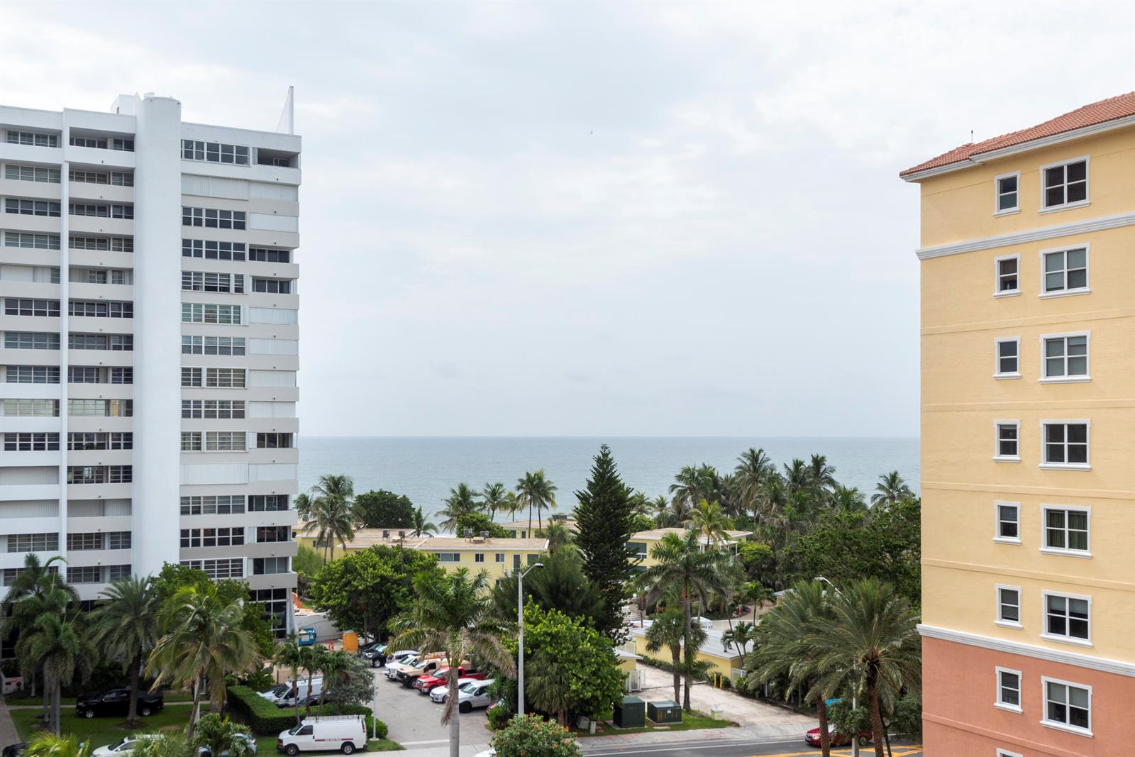 An exterior view shows two tall apartment buildings flanking a tropical landscape with ocean views — 1391 S Ocean Boulevard # 801, Pompano Beach FL 33062, POMPANO BEACH, FL