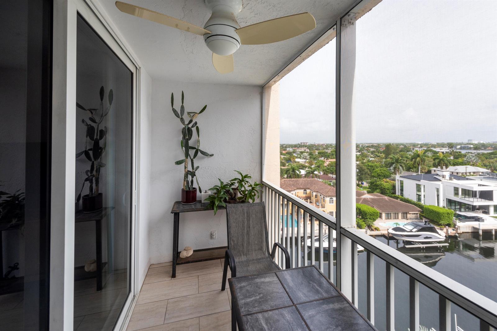 A balcony with a ceiling fan, tiled floor, plants, furniture, and a view of water — 1391 S Ocean Boulevard # 801, Pompano Beach FL 33062, POMPANO BEACH, FL