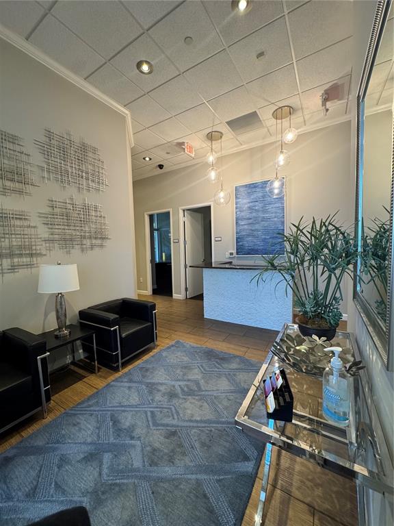 A modern office lobby features a reception desk, black leather seating, and a blue rug — 1112 CHANNELSIDE DRIVE UNIT CU3, TAMPA, FL