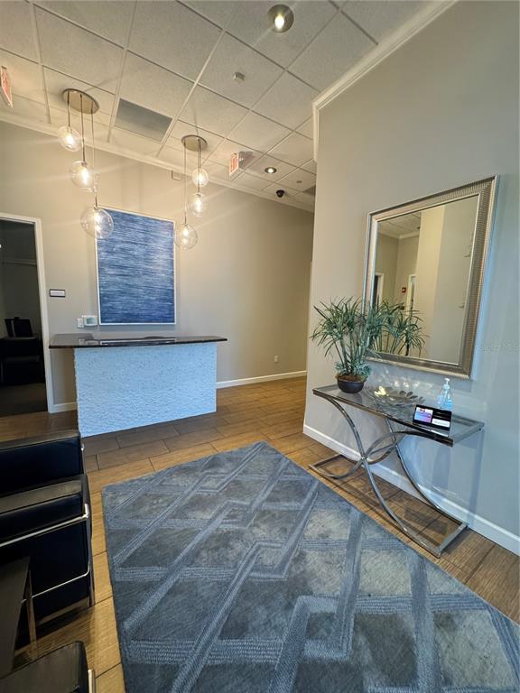 A reception area features a textured white desk, a blue abstract painting, and a rug — 1112 CHANNELSIDE DRIVE UNIT CU3, TAMPA, FL