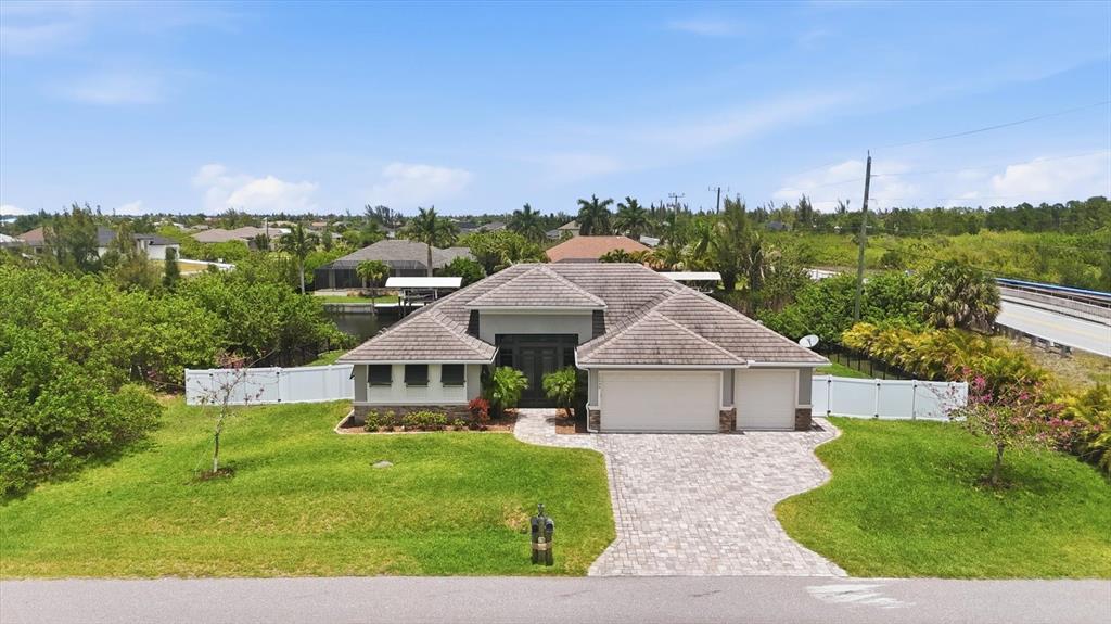 An aerial view of a single-story house with a tiled roof, paver driveway, and lawn — 15530 STAUNTON CIRCLE, PORT CHARLOTTE, FL
