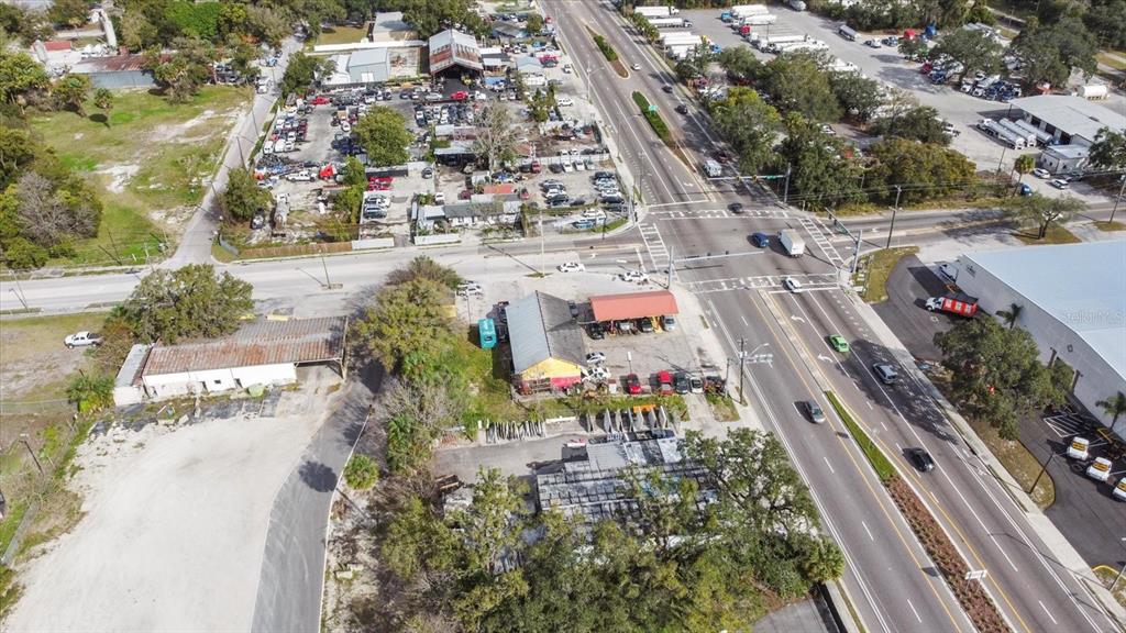 An aerial view shows a commercial property with several buildings, parking lots, and a busy intersection — 3550 N 40TH STREET, TAMPA, FL
