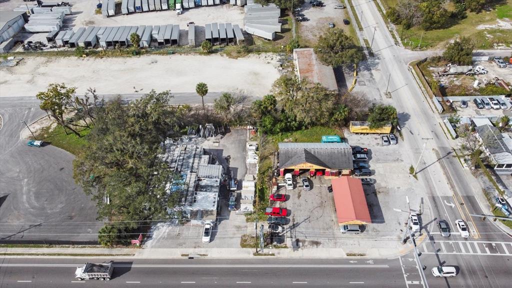 An aerial view shows a commercial property with a Quick Lube shop and adjacent lot — 3550 N 40TH STREET, TAMPA, FL