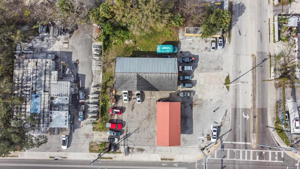 An aerial view shows a commercial property with two buildings, parking areas, and surrounding vegetation — 3550 N 40TH STREET, TAMPA, FL