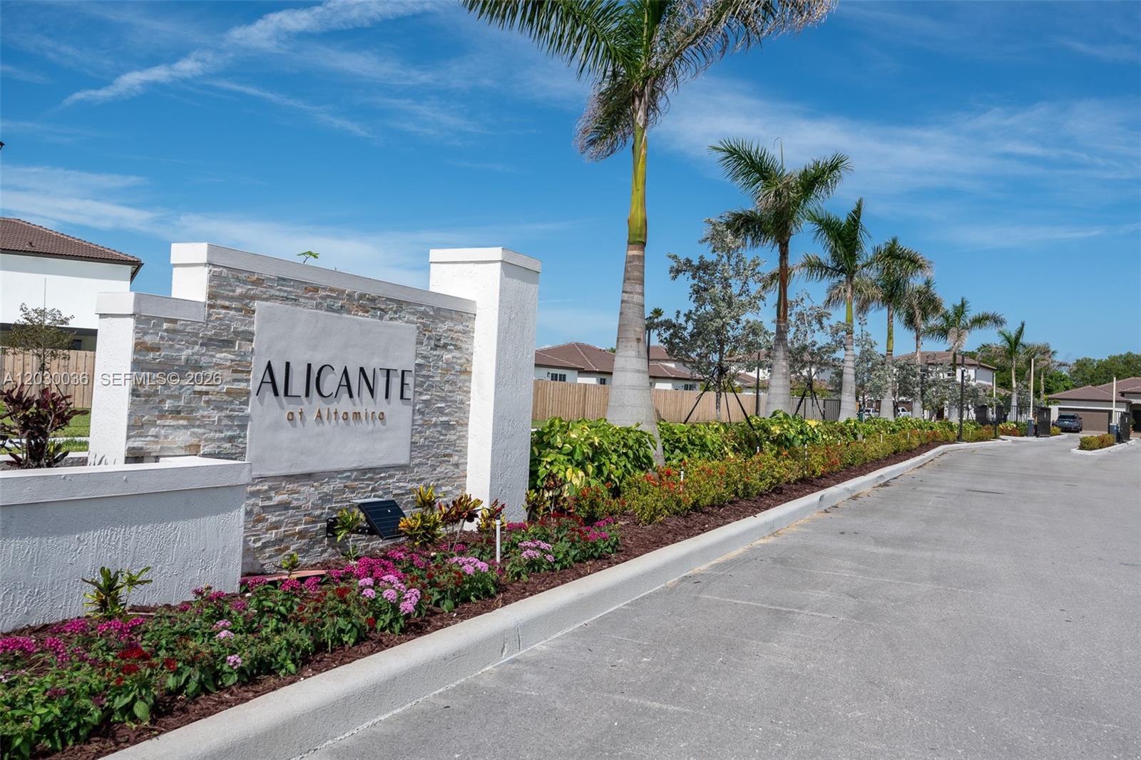 A stone monument sign for Alicante at Altamira stands beside a road with palm trees — 2485 SE 29th Dr, Homestead FL 33035, HOMESTEAD, FL
