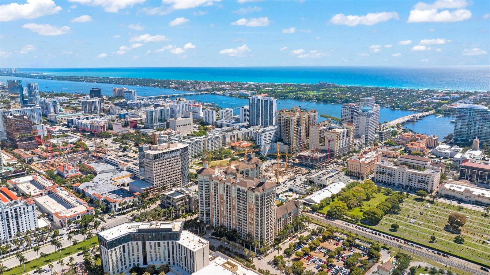 An aerial view of a coastal city featuring high-rise buildings, a bridge, and a cemetery — 550 Okeechobee Boulevard # 06, West Palm Beach FL 33401, WEST PALM BEACH, FL