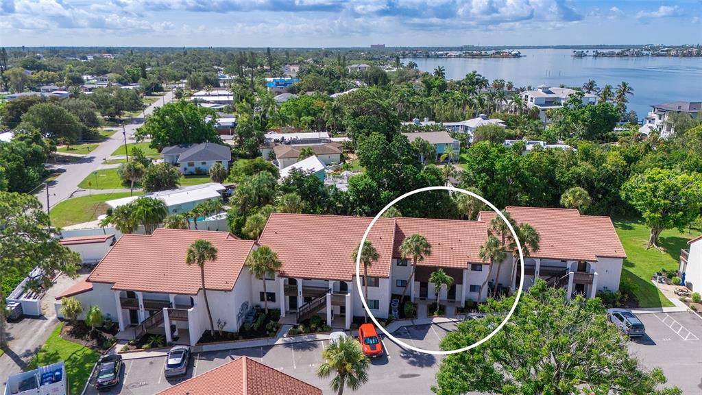 An aerial view shows a multi-unit residential building with a red tile roof — 1646 STICKNEY POINT ROAD UNIT 101, SARASOTA, FL