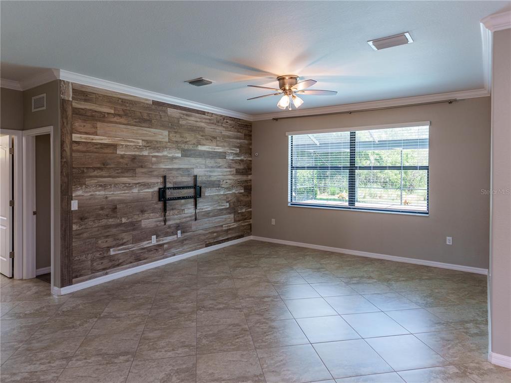 A white kitchen cabinet unit features a built-in stainless steel microwave and oven combination — 1588 VIZCAYA LANE, NAPLES, FL