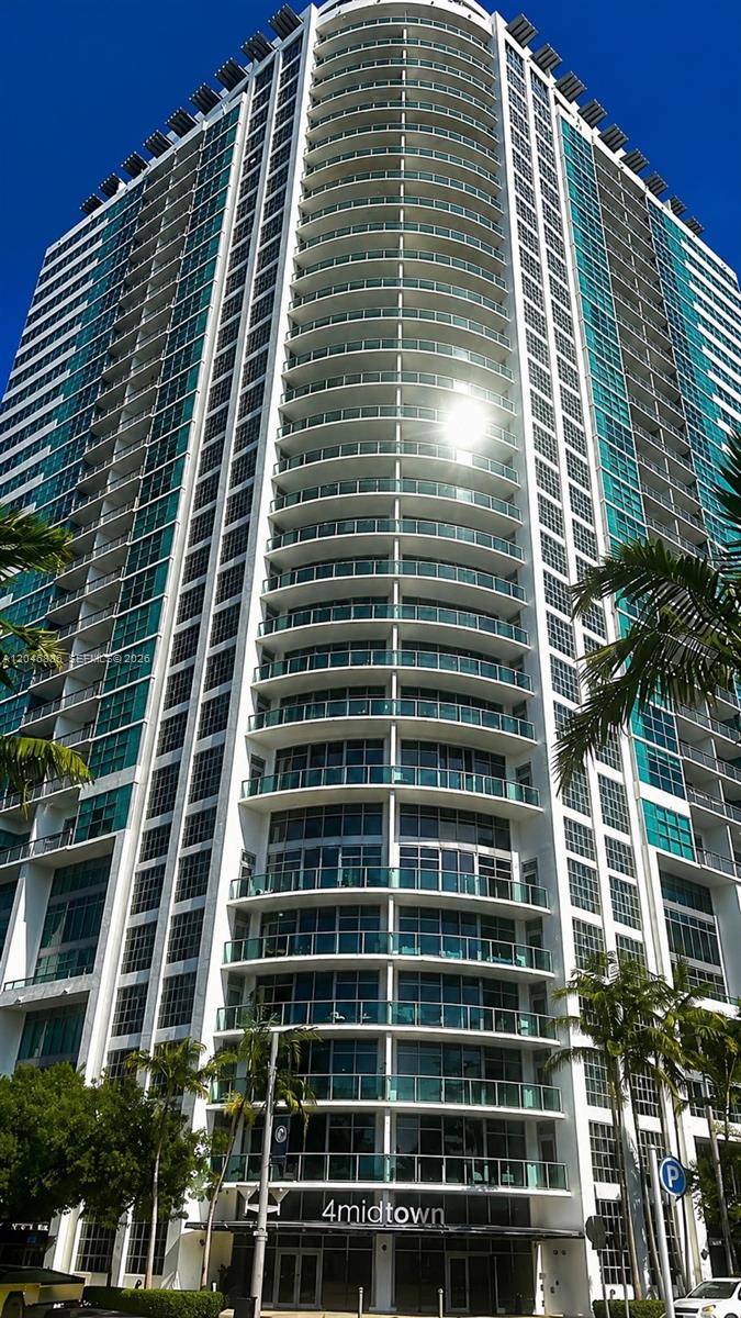 A low-angle view of the 4midtown high-rise residential building with glass balconies and palm trees — 3301 NE 1st Ave # H2113, Miami FL 33137, MIAMI, FL