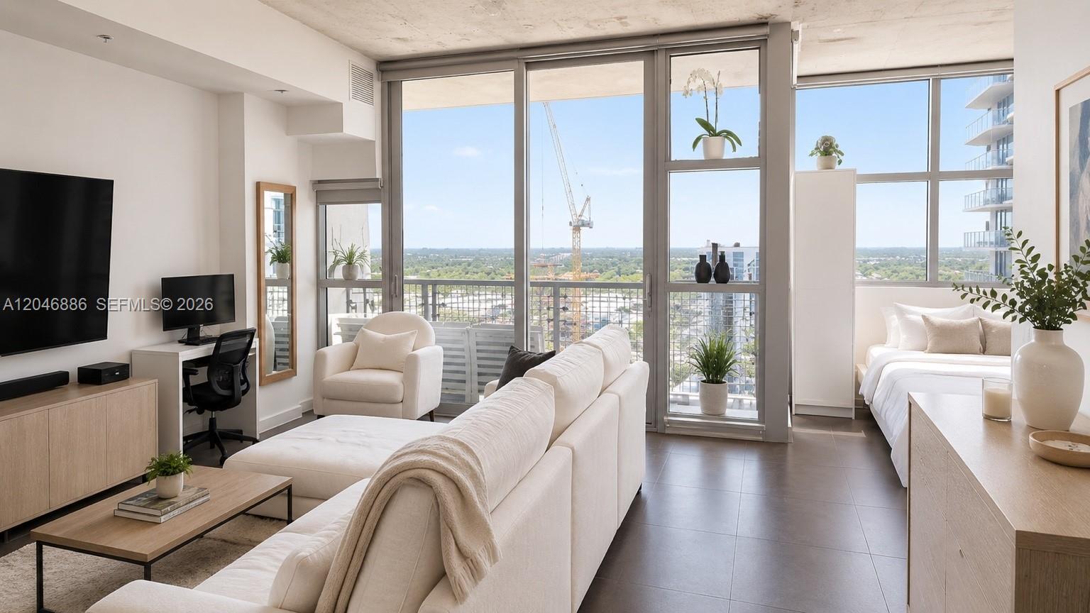 A modern studio apartment features a living area, workspace, and bedroom with floor-to-ceiling windows — 3301 NE 1st Ave # H2113, Miami FL 33137, MIAMI, FL