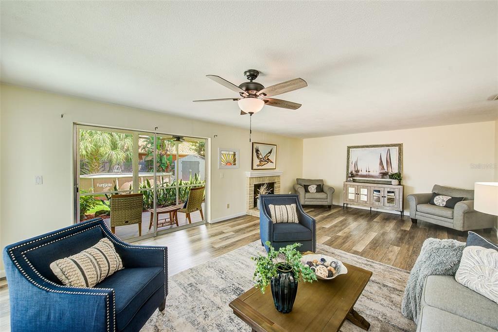 A single-story house with a light green exterior, a garage, and a front lawn — 14079 VICTORIA ROAD, LARGO, FL
