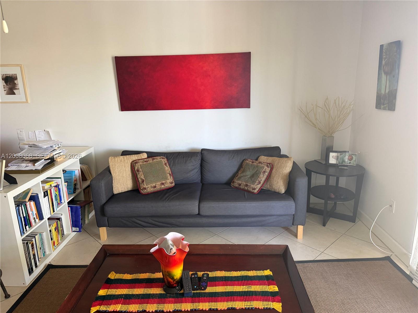 A living room features a dark gray sofa, a wooden coffee table, and a bookshelf — 8415 SW 107th Ave # 369W, Miami FL 33173, MIAMI, FL