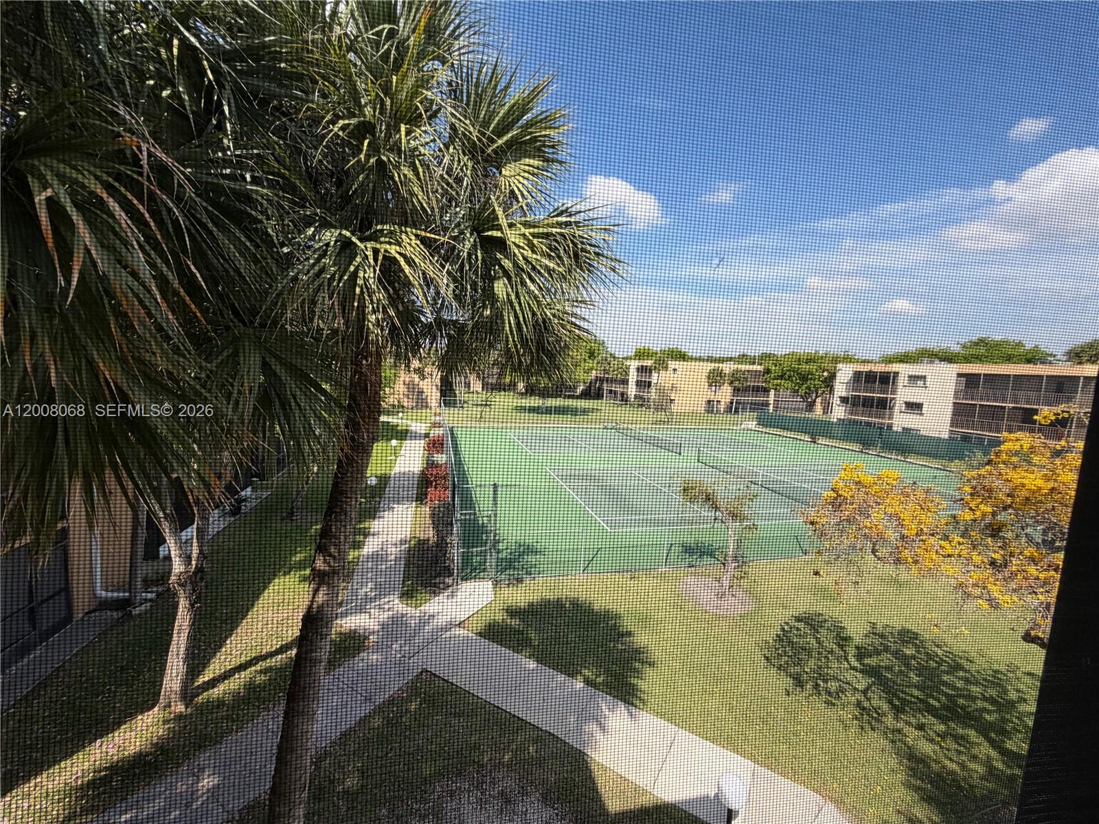 An elevated view shows a tennis court surrounded by palm trees and apartment buildings — 8415 SW 107th Ave # 369W, Miami FL 33173, MIAMI, FL
