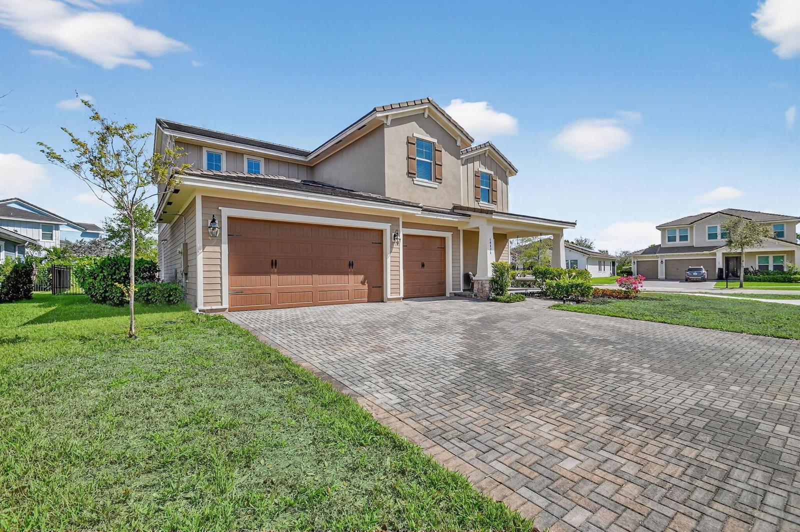 A two-story suburban house with a three-car garage and a paved driveway — 19535 Split Rail Run, Loxahatchee FL 33470, LOXAHATCHEE, FL