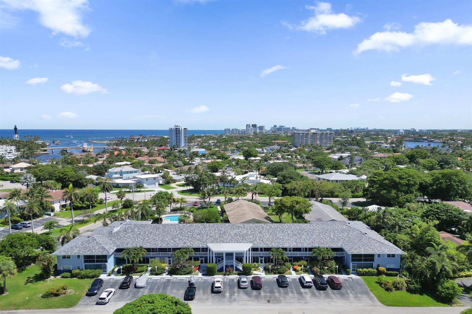 An aerial view shows a multi-story apartment building with a parking lot in front — 2734 NE 27th Court # 17, Lighthouse Point FL 33064, LIGHTHOUSE POINT, FL