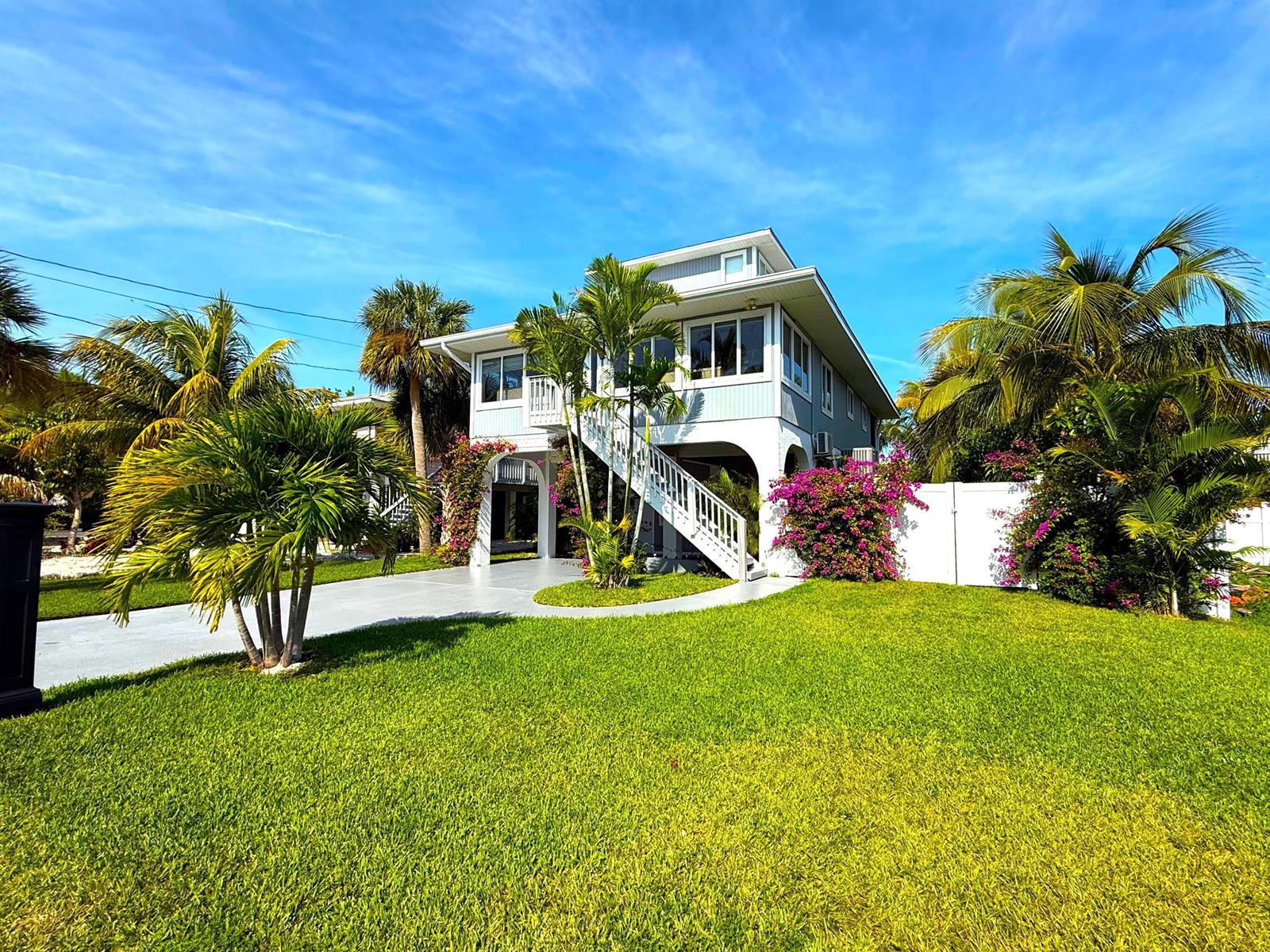 A two-story house with a white staircase, palm trees, and a green lawn — 27385 Saint Lucie Lane, FL 33042, FL