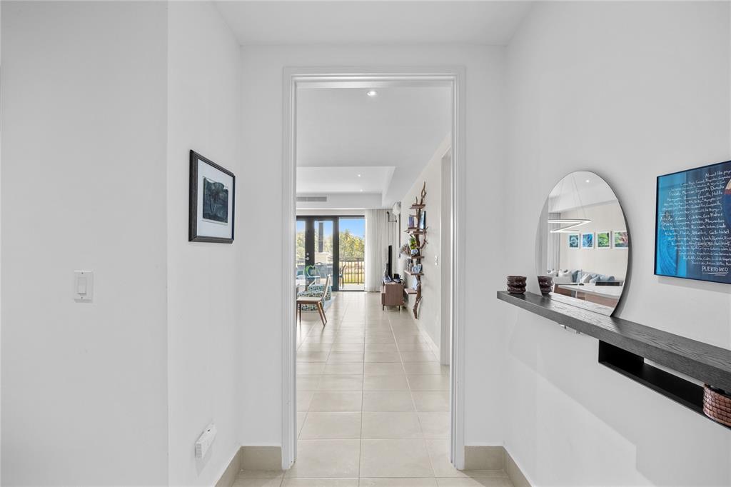 A bright hallway leads through a doorway into a living area with tile flooring — 7000 BAHIA BEACH DR UNIT 7258, RIO GRANDE, PR