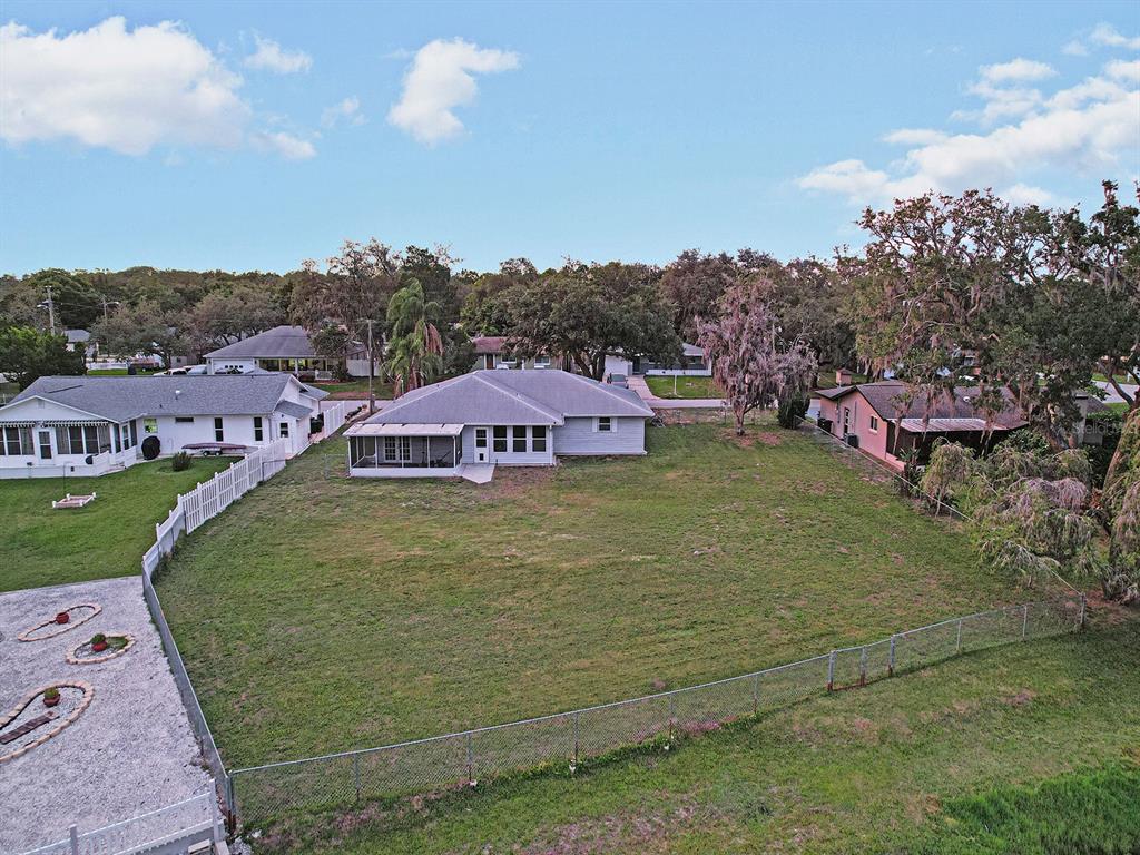An aerial view shows a single-story house with a screened porch and a large yard — 8310 LIMAN DRIVE, NEW PORT RICHEY, FL