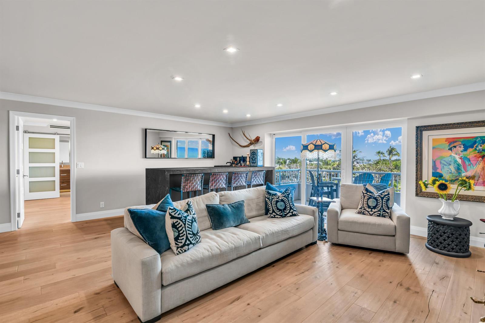 A living room features a bar, a sofa, an armchair, and a balcony with ocean views — 600 S Ocean Boulevard # 407, Boca Raton FL 33432, BOCA RATON, FL