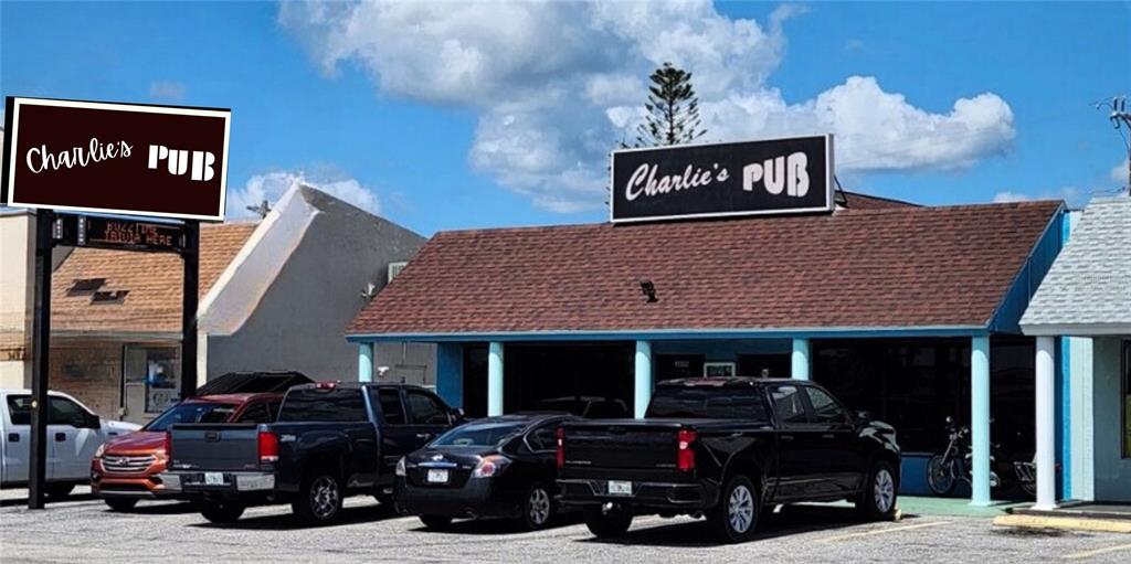 The exterior of a commercial building features a sign for Charlie's Pub and a parking lot — 3496 TAMIAMI TRAIL, PORT CHARLOTTE, FL