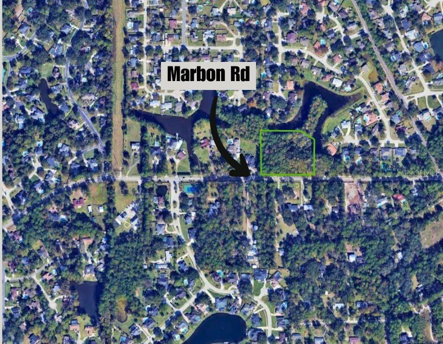 An aerial map view shows a wooded, rectangular lot outlined in green along a road — MARBON ROAD, JACKSONVILLE, FL