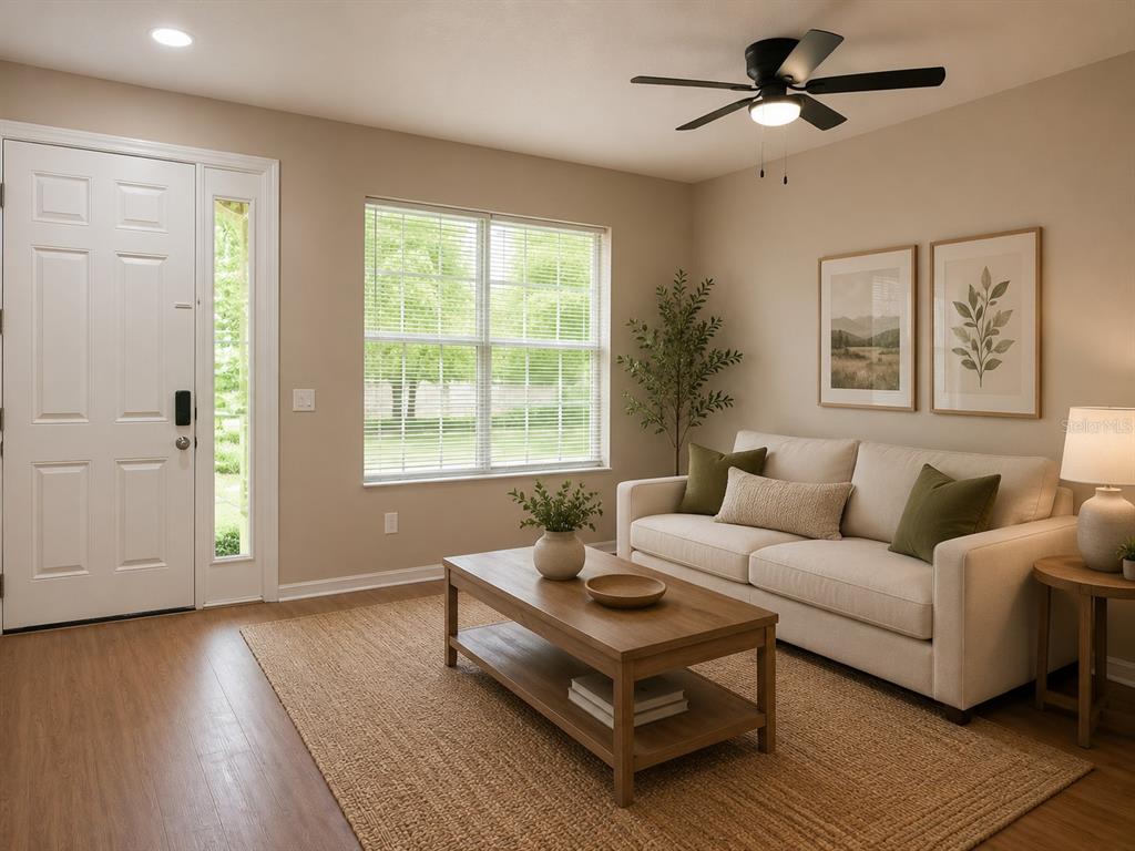 A living room with a beige sofa, wooden coffee table, and a white front door — 1124 FENNEL GREEN DR, SEFFNER, FL