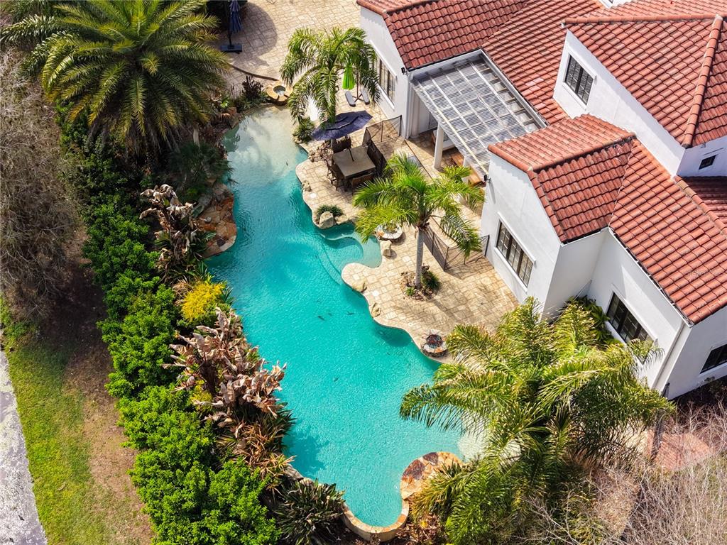 An aerial view shows a house with a red tile roof and a swimming pool — 719 EASTLAWN DRIVE, KISSIMMEE, FL