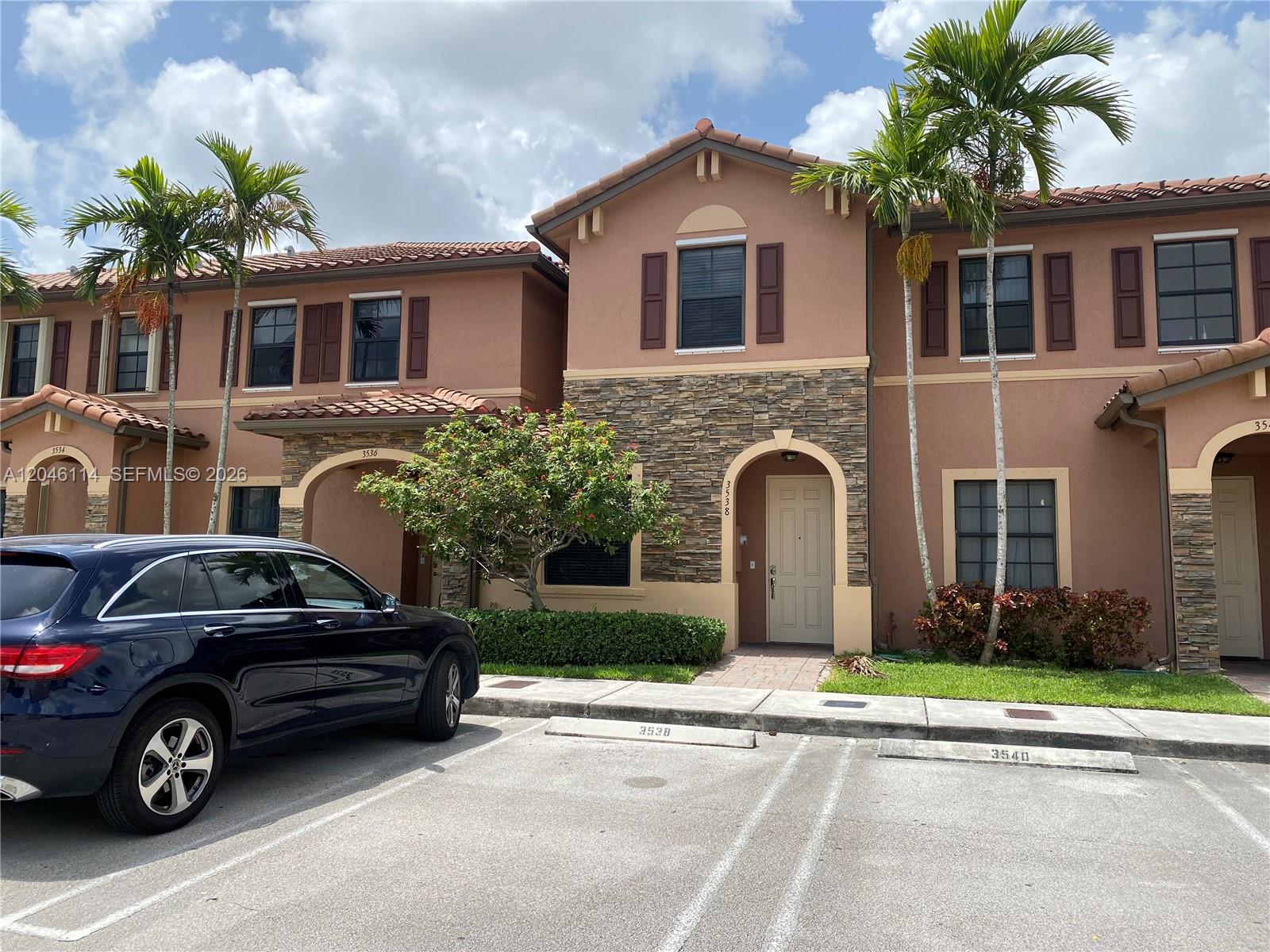 A two-story townhouse exterior features stucco walls, stone accents, and a tiled roof — 3538 W 88th Terrace # 3538, Hialeah Gardens FL 33018, HIALEAH GARDENS, FL