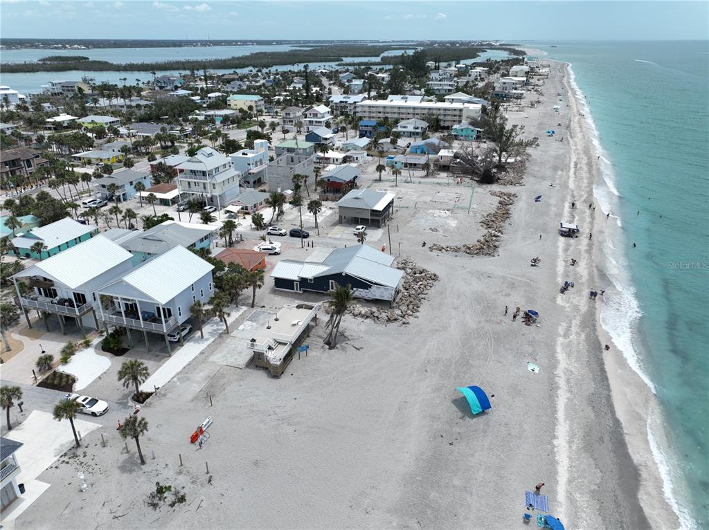 An aerial view of a sandy beach with houses, palm trees, and the ocean — 45 COQUINA LANE, ENGLEWOOD, FL