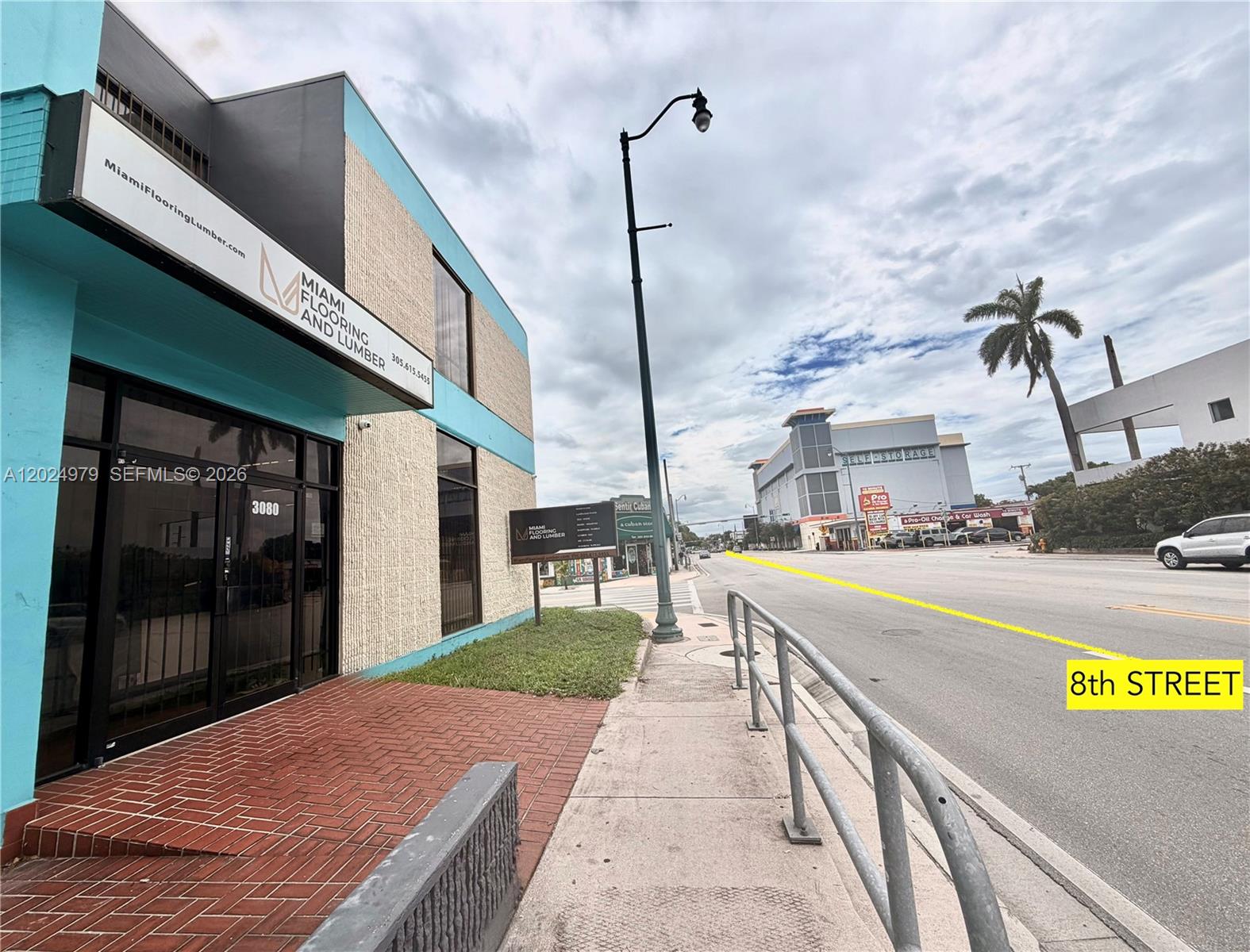 A street-level view shows the exterior of a commercial building with a brick entrance — 3080 SW 8th St, Miami FL 33135, MIAMI, FL