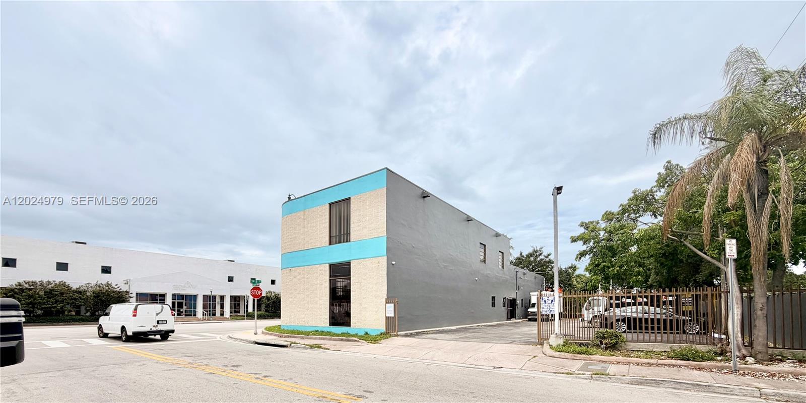 A two-story commercial building with gray and light blue exterior walls sits on a corner — 3080 SW 8th St, Miami FL 33135, MIAMI, FL